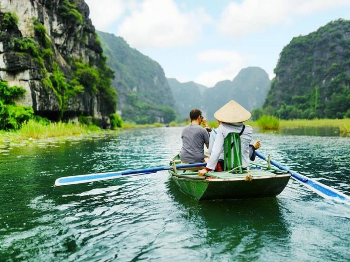 Du khách ngồi thuyền xuôi sông Ngô Đồng ngắm núi đá vôi hùng vĩ. (Nguồn: Sưu tầm)